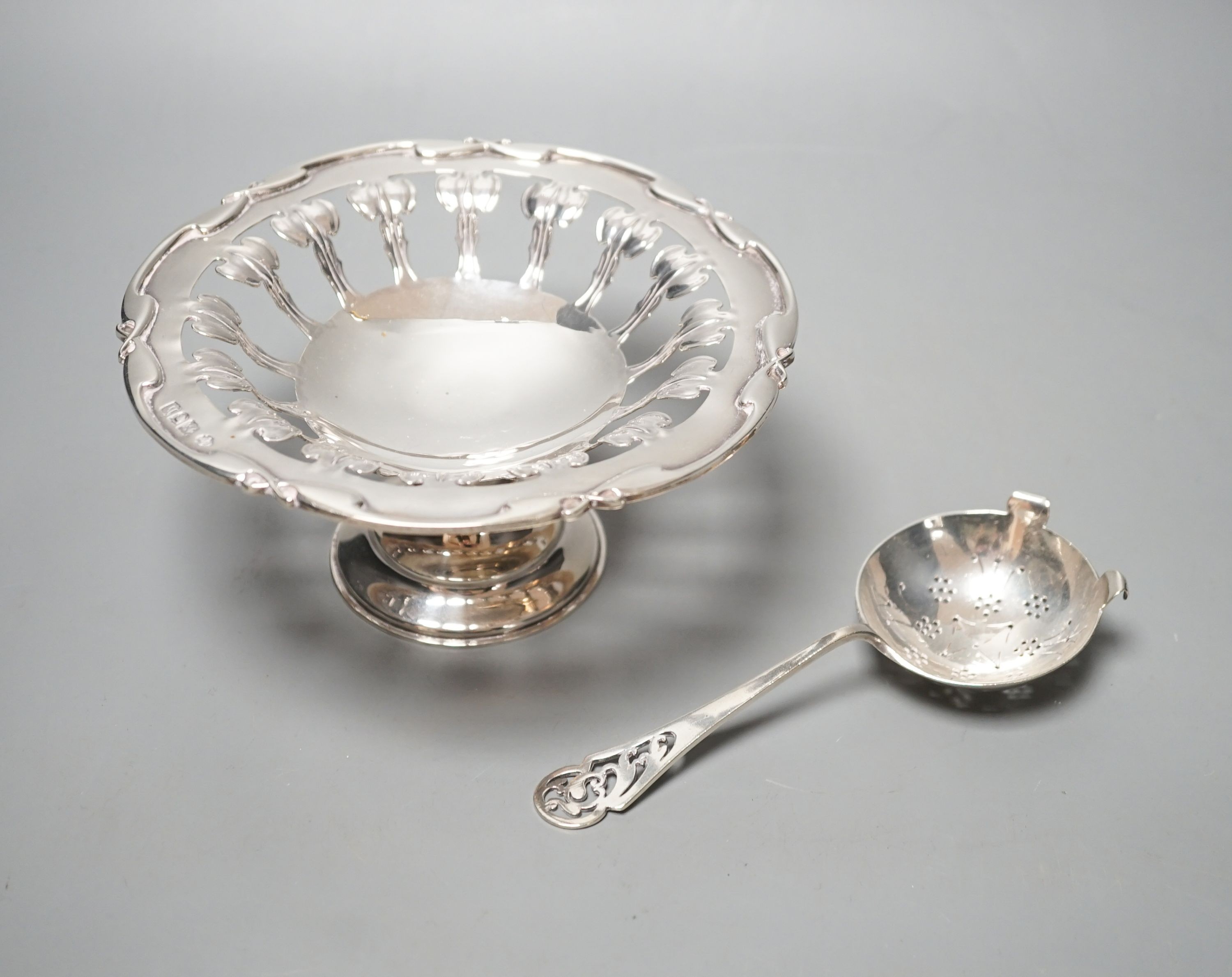 A Edwardian Art Nouveau pierced silver comport, William Hutton & Sons, London, 1903, 15.7cm diameter and a silver sifter spoon, 6.5oz.